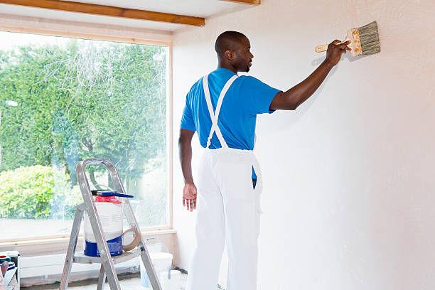 Person painting wall