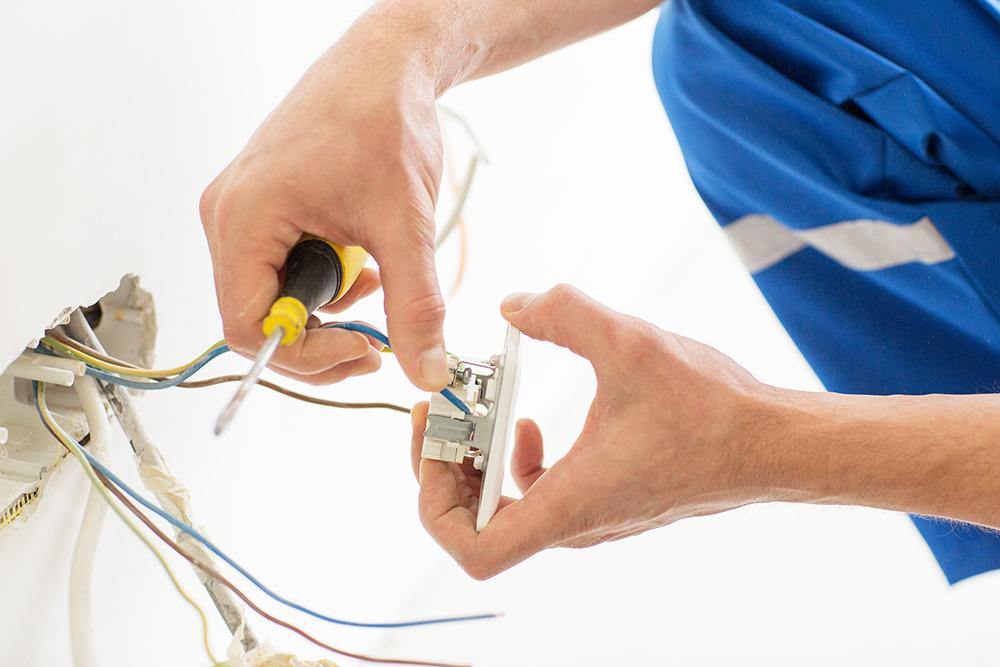 Electrician working on outlet